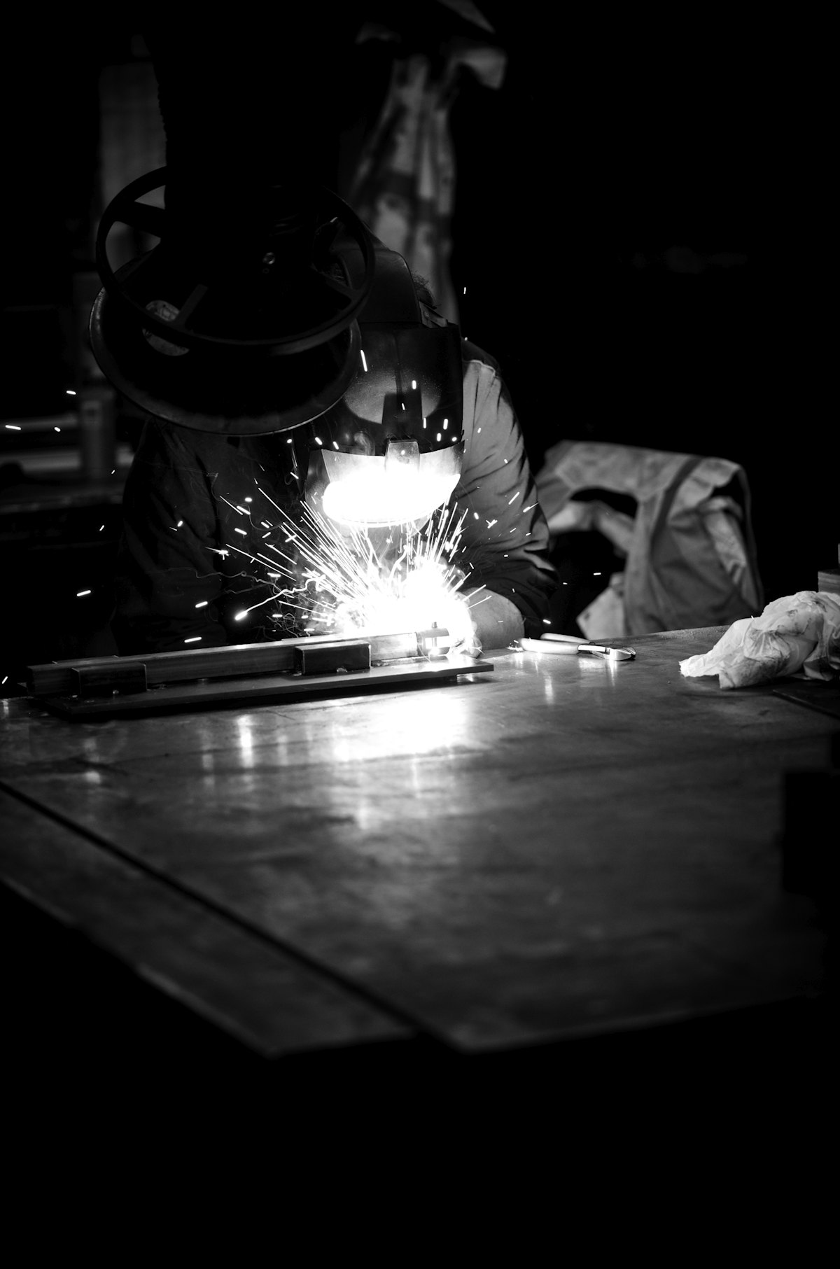 A welder at work with sparks flying (illustrative stock photo)